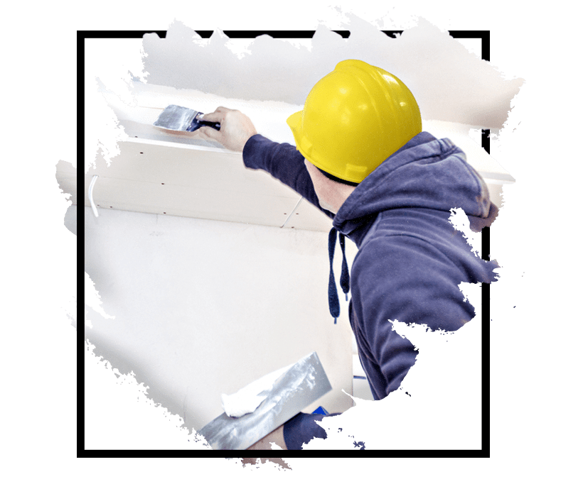 A man painting a wall, possibly during a renovation or decoration project